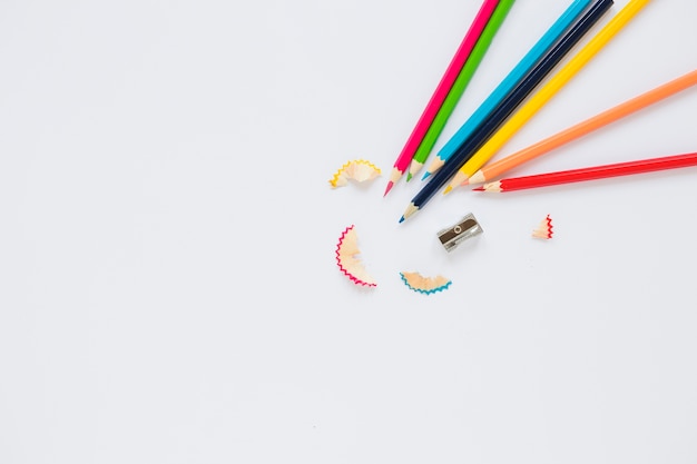 Bright pencils near sharpener and shaving