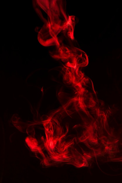 Bright red smoke waves on black background