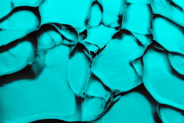 Free photo bright turquoise paint with black color lines over cracked textured background