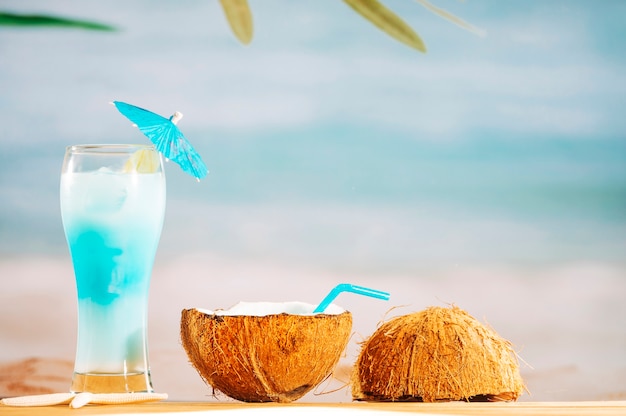 Free Photo bright umbrella decorated cocktail and coconut milk with straw