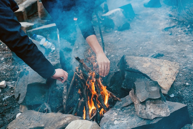 Bright yellow bonfire on gray sand