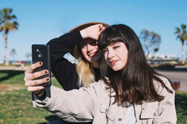 Bright young girls taking selfie for memory