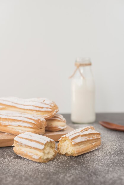 Broken homemade eclairs against white background