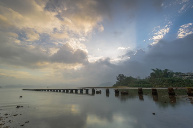 Broken pier in the lake during the sunrise in Hong Kong