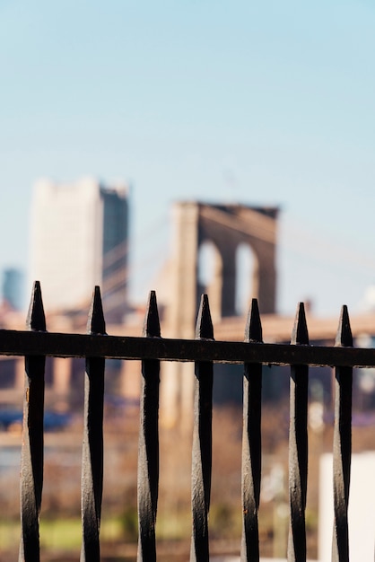 Free photo brooklyn bridge through black fence