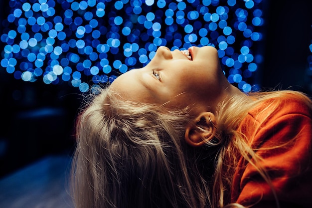 brother and sister on the background of a festive garland, New Year lights, children.