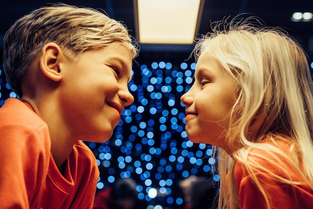 brother and sister on the background of a festive garland, New Year lights, children.