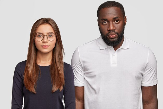 Brother and sister of different races look seriously