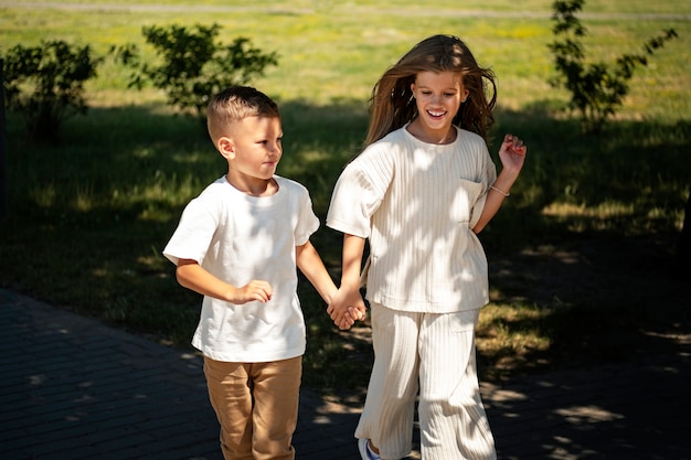 Free photo brother and sister having fun at the outdoors playground