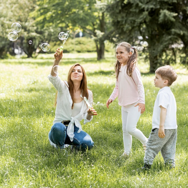 Brother and sister playing with their mom