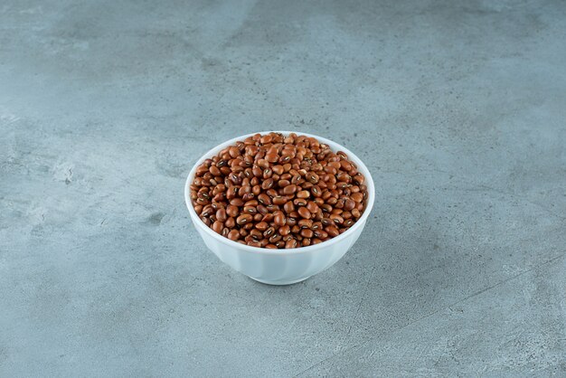 Brown beans in a white ceramic cup. High quality photo