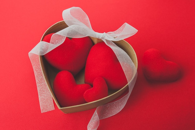 Brown box with hearts inside and a white bow