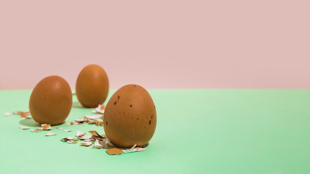 Brown chicken eggs with broken shell on table