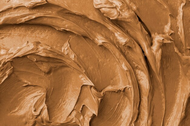 Brown frosting texture background close-up