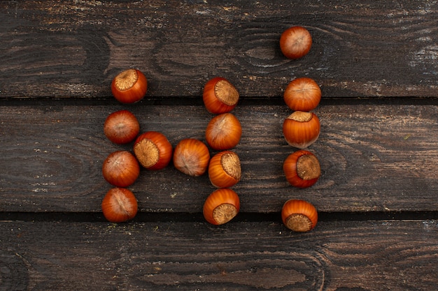 Brown nuts whole tasty on a brown wooden rustic table