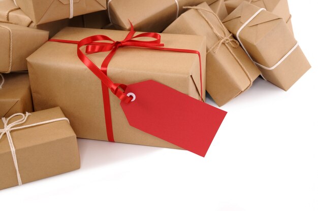 Brown paper packages with red gift tag