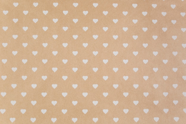 Free photo brown paper with white hearts