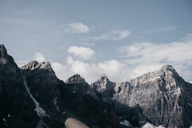 Brown rocky mountain under white clouds during daytime