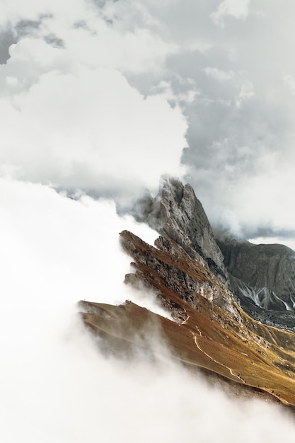 Brown rocky mountain under white clouds