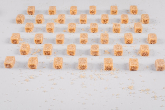 Free Photo brown sugar cubes lined up with high angle view