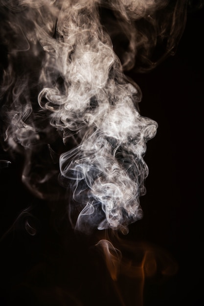 Free photo brown wavy smoke on black background