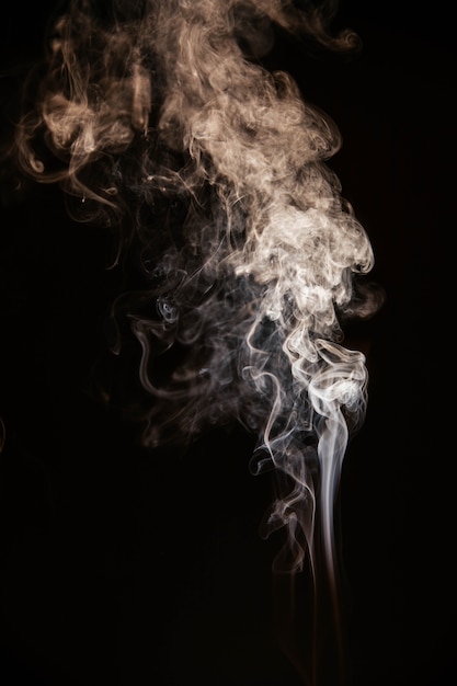 Free photo brown wavy smoke on black background