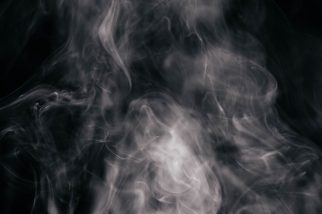 Free photo brown wavy smoke on black background