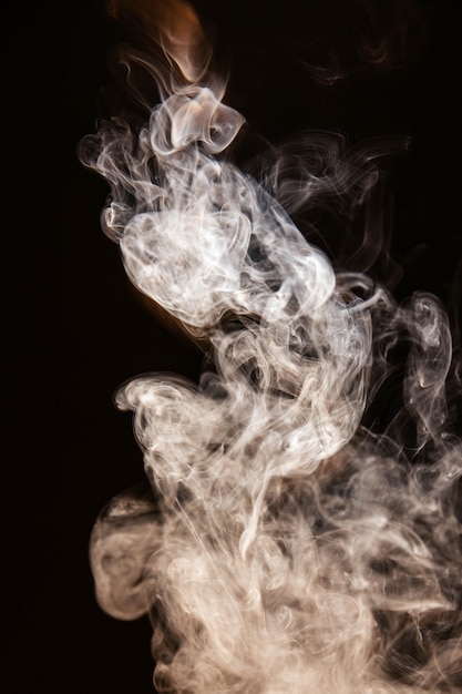 Free Photo brown wavy smoke on black background