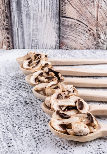 Brown and white mushrooms in a sack cloth top view