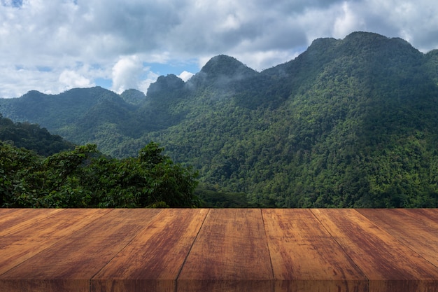 Free Photo brown wood floor with green mountain .