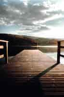 Free photo brown wooden dock on lake during daytime