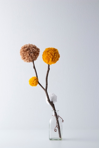 Free Photo brown and yellow pom poms in vase