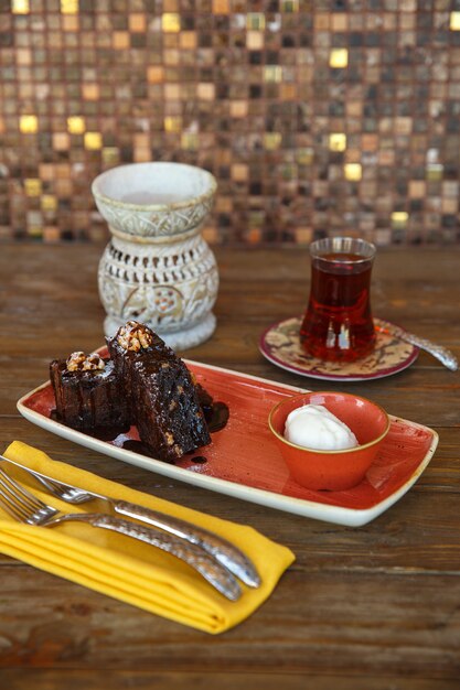 Brownie pieces with vanilla ice cream served with black tea