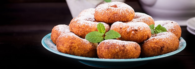 Free Photo brunch or lunch. homemade donuts sprinkled with powdered sugar.