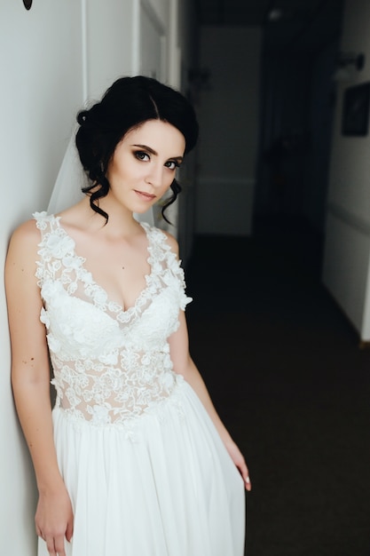 Brunette bride posing with her dress