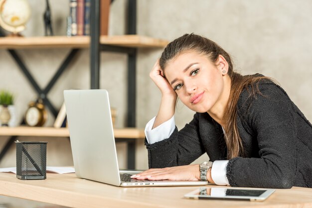 Brunette businesswoman bored at her office