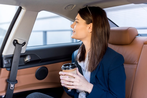 Brunette businesswoman inside a car