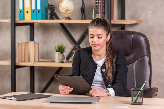 Brunette businesswoman reading document 