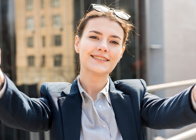 Free Photo brunette businesswoman taking a selfie