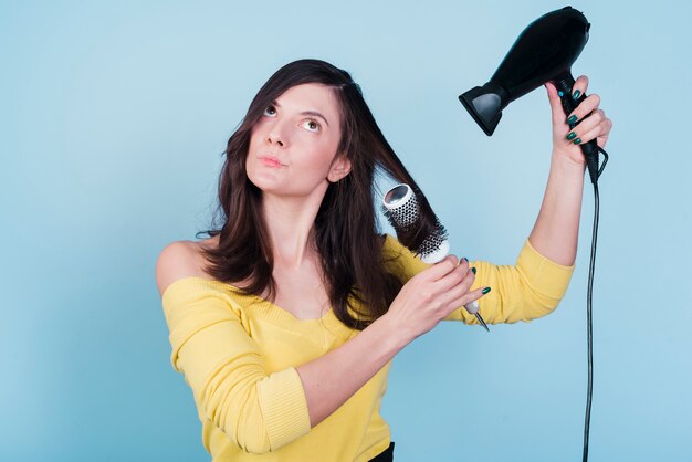 Brunette girl drying her hair