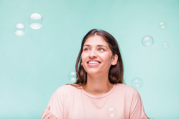 Free Photo brunette girl playing with soap bubbles