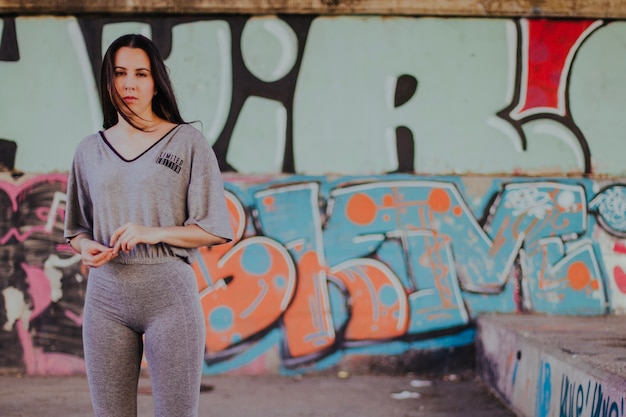 Brunette girl standing outside posing