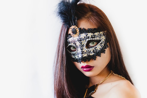 Free Photo brunette girl with a white venetian mask