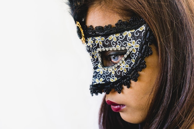 Brunette girl with a white venetian mask