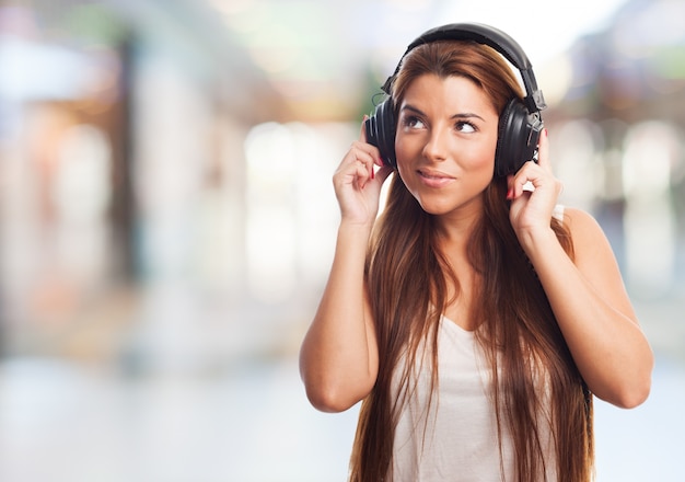 Brunette listening music in headphones