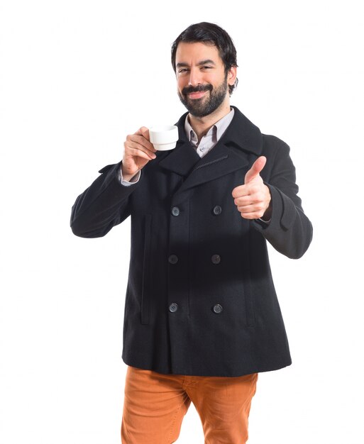 Brunette man holding a cup of coffee