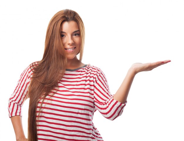 Brunette woman displaying copy space with hand.