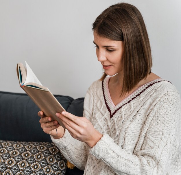 A brunette woman reading a book