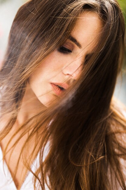 Brunette woman smokes a cigar