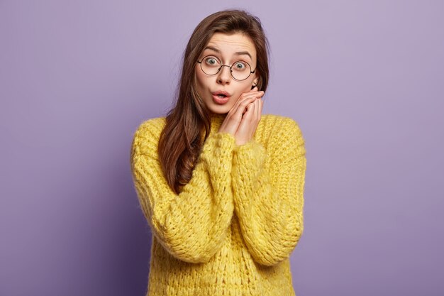 Brunette woman wearing yellow sweater